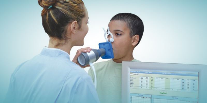 A child using a spirometer in a lung function test