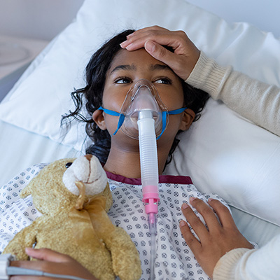 Child In Bed Wearing Oxygen Mask