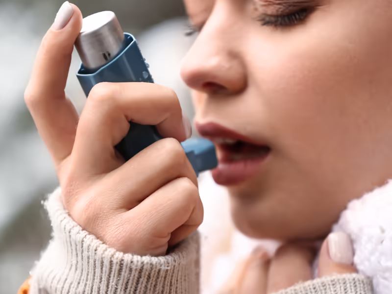 Close Up Of Child Using Inhaler
