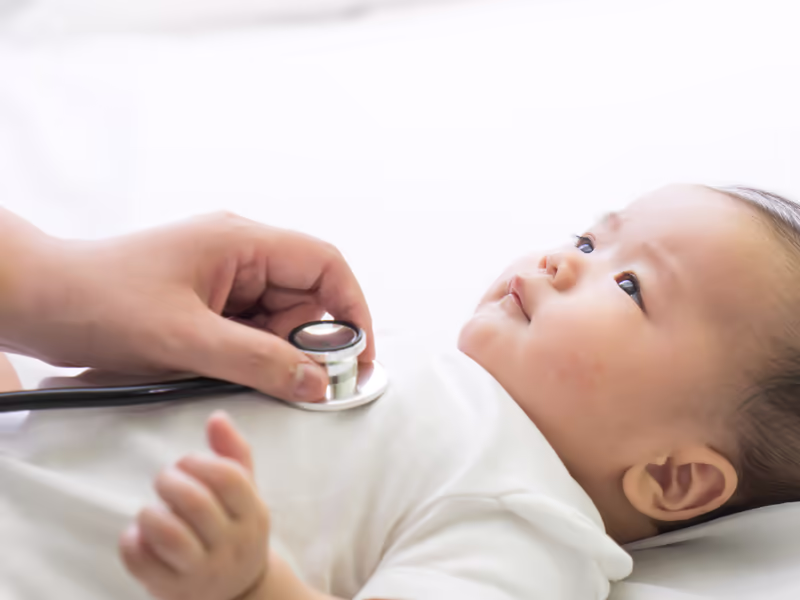 Hand Holding A Stethoscope On A Babys Chest