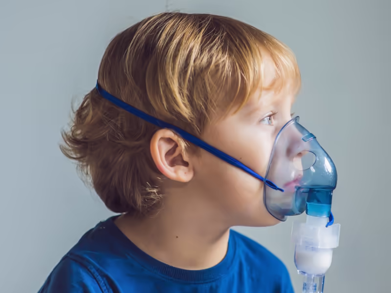 Young Boy Wearing Nebuliser Mask